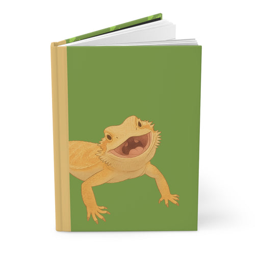 Notebook with a smiling bearded dragon illustration on a green background